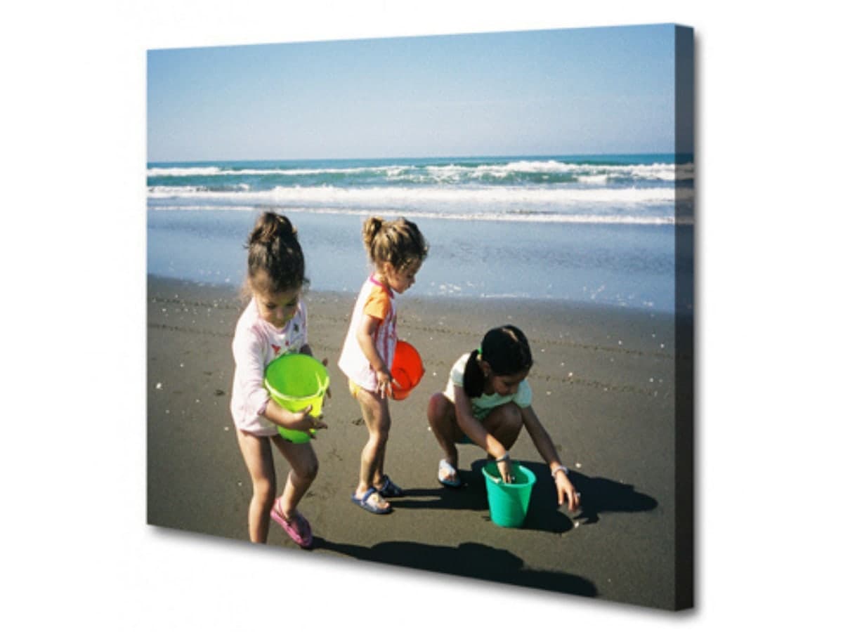 A stretched canvas print of three children on a beach