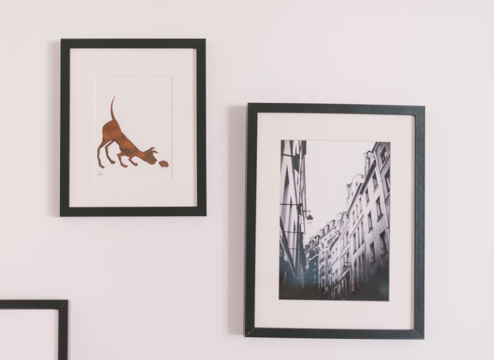 A black-framed photograph with a white mount on a gallery wall